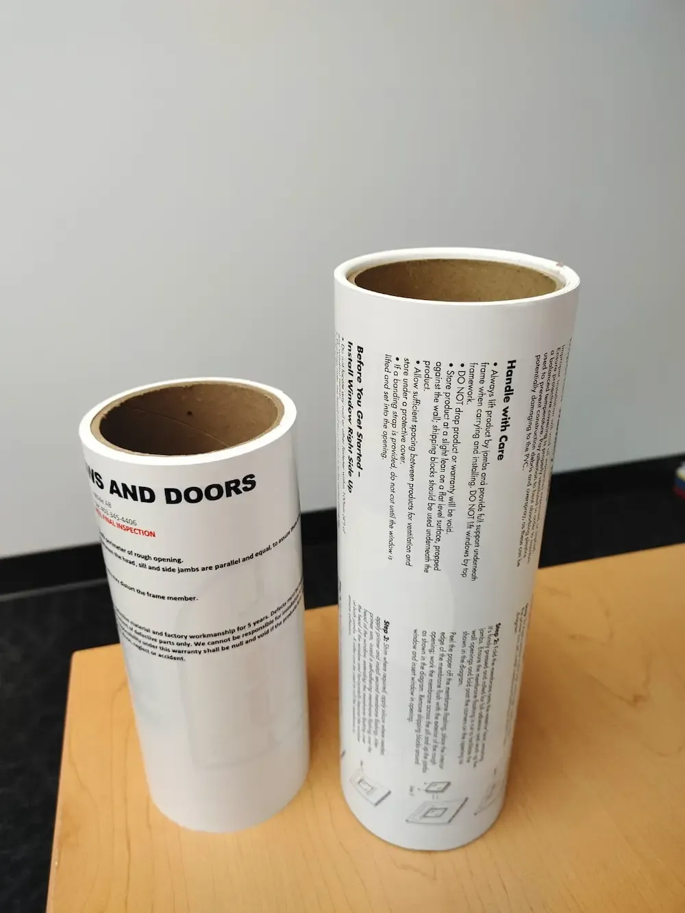 An image of two liner less label rolls side-by-side with sample information on them.