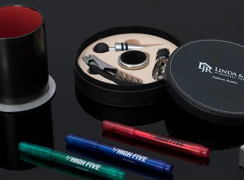 An image of promotional products for business branding, pens and mugs with logos.