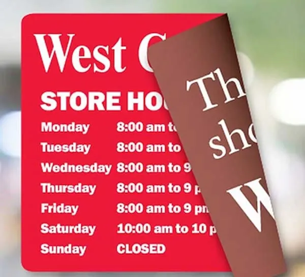 An image of a linerless label displaying how it can be placed on a window displaying store hours.